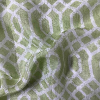 white geometric figures green muslin fabric